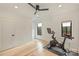 Exercise room featuring hardwood floors, a ceiling fan and a Peloton at 6133 Berryhill Towns Dr, Charlotte, NC 28270