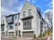 Townhome boasts an elegant painted brick facade, a two-car garage, and professionally landscaped yard at 6133 Berryhill Towns Dr, Charlotte, NC 28270