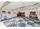 Clean, well-lit garage with checkered floors and organized tool storage units at 6133 Berryhill Towns Dr, Charlotte, NC 28270