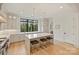 This kitchen is equipped with white cabinets, hardwood floors, and a center island with bar stool seating at 6133 Berryhill Towns Dr, Charlotte, NC 28270