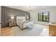 Serene main bedroom with modern wall trim, a large window, and hardwood floors at 6133 Berryhill Towns Dr, Charlotte, NC 28270