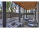 Modern patio features a stained wood ceiling, stone flooring, and stylish gray outdoor furniture at 6133 Berryhill Towns Dr, Charlotte, NC 28270