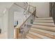 Elegant staircase with wood and black iron detailing, and modern lighting at 6133 Berryhill Towns Dr, Charlotte, NC 28270