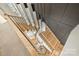 Elegant staircase featuring light wood steps, black iron railing, and a stunning modern chandelier at 6133 Berryhill Towns Dr, Charlotte, NC 28270