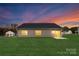 Gray house exterior with lawn, backyard, and sunset in background at 681 Journey Sw St, Concord, NC 28025