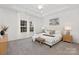 Bright main bedroom featuring a king-size bed and hardwood floors at 681 Journey Sw St, Concord, NC 28025