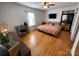 Comfortable bedroom features wood floors, a modern ceiling fan, and ample natural light from the window at 7860 Georgia Ave, Kannapolis, NC 28081