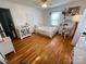 Airy bedroom with hardwood floors, a ceiling fan, and ample natural light from the window at 7860 Georgia Ave, Kannapolis, NC 28081