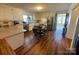 Spacious eat-in kitchen featuring white cabinets, a stainless steel refrigerator, and hardwood floors at 7860 Georgia Ave, Kannapolis, NC 28081