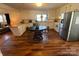 Bright kitchen with white cabinets, stainless steel appliances, and a breakfast bar that opens to the living area at 7860 Georgia Ave, Kannapolis, NC 28081