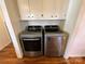 Convenient laundry area showcasing modern, front-loading washer and dryer units with white cabinetry above at 7860 Georgia Ave, Kannapolis, NC 28081