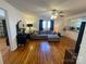 Stylish living room with hardwood floors, a gray sectional, seamlessly connected to the kitchen area at 7860 Georgia Ave, Kannapolis, NC 28081