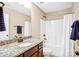 Bathroom featuring a vanity with granite countertop, framed mirror, shower/tub with curtain at 79031 Ridgehaven Rd, Lancaster, SC 29720