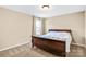 Bedroom with beige walls, carpeted floor, and a window with curtain providing natural light at 79031 Ridgehaven Rd, Lancaster, SC 29720