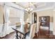 Elegant dining room featuring hardwood floors, a tray ceiling, and chandelier at 79031 Ridgehaven Rd, Lancaster, SC 29720