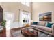 Bright living room featuring hardwood floors, large windows, and a comfortable couch with blue throw pillows at 79031 Ridgehaven Rd, Lancaster, SC 29720