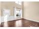 Bright living room featuring hardwood floors, high ceilings, and large windows with natural light at 79031 Ridgehaven Rd, Lancaster, SC 29720