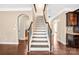 Staircase with dark wood floors and white trim at 79031 Ridgehaven Rd, Lancaster, SC 29720