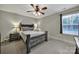 Bedroom features a dark wood bedframe, neutral walls, and natural light at 849 Treva Anne Sw Dr, Concord, NC 28027