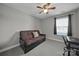 Neutral bedroom features a futon, ceiling fan, and a cozy atmosphere at 849 Treva Anne Sw Dr, Concord, NC 28027