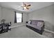 Neutral bedroom features a futon, ceiling fan, and a calming atmosphere at 849 Treva Anne Sw Dr, Concord, NC 28027