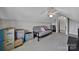 Bonus room featuring a futon, boxes, and a ceiling fan at 849 Treva Anne Sw Dr, Concord, NC 28027