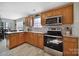 Modern kitchen featuring wood cabinets, stainless steel appliances, and neutral paint colors at 849 Treva Anne Sw Dr, Concord, NC 28027