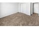 Bright bedroom with neutral carpeting and double door closet at 8835 Merrie Rose Ave, Charlotte, NC 28213