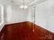 Formal dining room with hardwood floors and chandelier at 8835 Merrie Rose Ave, Charlotte, NC 28213