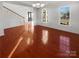 Bright dining room featuring hardwood floors and wainscoting at 8835 Merrie Rose Ave, Charlotte, NC 28213