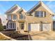 Two-story brick home with a two-car garage and landscaped yard at 8835 Merrie Rose Ave, Charlotte, NC 28213