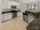 Modern kitchen with stainless steel appliances and granite countertops at 8835 Merrie Rose Ave, Charlotte, NC 28213