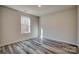 Bright bedroom featuring a large window and wood-look floors at 100 Howell St # 13A, Hickory, NC 28601