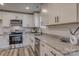 Modern kitchen with white cabinets, granite countertops, and stainless steel appliances at 100 Howell St # 13A, Hickory, NC 28601