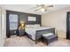 Cozy bedroom featuring dark accent wall, ceiling fan, window and leather bench at the end of the bed at 1025 Twin Lakes Rd, Rock Hill, SC 29732