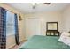 Bedroom featuring carpeted floors, ceiling fan, black shelf, window with curtains and double door closet at 1025 Twin Lakes Rd, Rock Hill, SC 29732