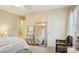 Carpeted bedroom with large mirror, wicker chair, ceiling fan and ample natural light at 1025 Twin Lakes Rd, Rock Hill, SC 29732