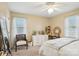 Well-lit bedroom with a ceiling fan, window, dresser, mirror, and chair at 1025 Twin Lakes Rd, Rock Hill, SC 29732