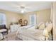 Bright bedroom with a ceiling fan, window, dresser, and cozy chair at 1025 Twin Lakes Rd, Rock Hill, SC 29732