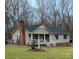 Tan ranch house with a porch and American flag, nestled on a spacious lawn at 1025 Twin Lakes Rd, Rock Hill, SC 29732