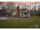 Charming home featuring a brick chimney and a welcoming front porch, surrounded by a well-manicured lawn and trees at 1025 Twin Lakes Rd, Rock Hill, SC 29732