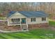 Charming home featuring a welcoming front porch, blue front door and well-manicured lawn at 1025 Twin Lakes Rd, Rock Hill, SC 29732