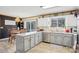 Bright kitchen with white cabinets, stainless steel appliances, and an adjacent dining area with a modern chandelier at 1025 Twin Lakes Rd, Rock Hill, SC 29732