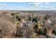 Aerial view of a home with an in-ground pool and beautifully landscaped backyard and surrounding mature trees at 110 Lynbrook Dr, Davidson, NC 28036