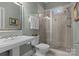 Bathroom with a glass shower, stylish vanity mirror, and sink with a view of the sky through a window at 110 Lynbrook Dr, Davidson, NC 28036