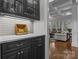 Butler's Pantry with dark cabinets, marble countertops, mosaic backsplash, and access to a living room at 110 Lynbrook Dr, Davidson, NC 28036