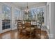 Bright dining room features many windows, hardwood floors, and elegant chandelier at 110 Lynbrook Dr, Davidson, NC 28036