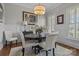 The dining room is well lit and features a chandelier, a round table, and wainscotting at 110 Lynbrook Dr, Davidson, NC 28036