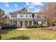 Beautiful two-story home with inviting front porch, lush lawn and meticulously maintained landscaping at 110 Lynbrook Dr, Davidson, NC 28036