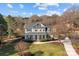 Elegant two-story home with a large front yard, long driveway, and meticulously manicured landscaping at 110 Lynbrook Dr, Davidson, NC 28036